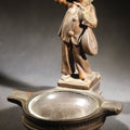 Lot 052 - Antique Copper-Clad Composition Figural Ashtray, Standing Pierrot Clown Holding A Lute, Glass Tray Insert, 6-5/8" H