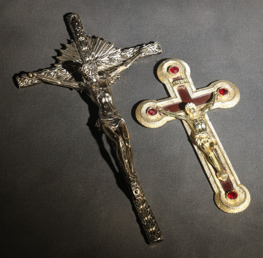 Lot 063 - Pair Of Vintage Metal Crucifixes, One Silver-Toned With Foliate Halo And One Gold-Toned With Red Cabochons And Enamel Inlay