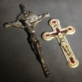 Lot 063 - Pair Of Vintage Metal Crucifixes, One Silver-Toned With Foliate Halo And One Gold-Toned With Red Cabochons And Enamel Inlay