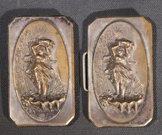 Lot 081 - Antique Silver-Plated Two-Piece Belt Buckle With Embossed Figural Woman Carrying Water Jug In Garden Setting