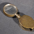 Lot 082 - Antique Brass Folding Pocket Loupe Magnifying Glass With Swivel Ring, 2" H