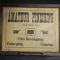 Lot 108 - Antique "Amateur Finishing" Film Developing, Enlarging, And Copying Advertising Sign, White Mt. Studio, Littleton, New Hampshire, Framed With Manicule Graphics, 15-1/2" x 12-1/2"