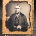 Lot 112 - Antique 1/6th Plate Daguerreotype Photograph, Uncased, Portrait Of A Middle-Aged Man With Chin Beard Holding A Book, Cartouche-Form Brass Mat