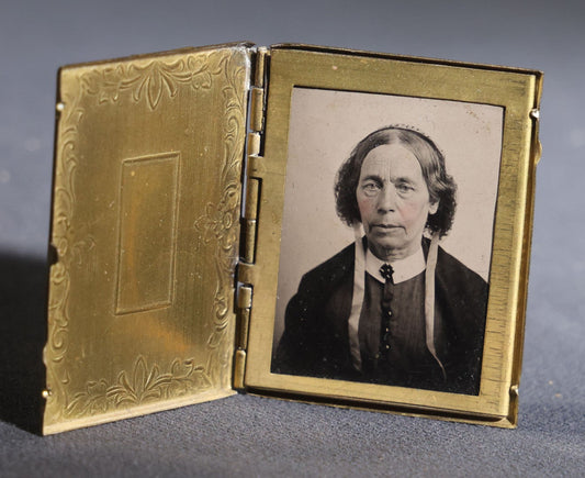 Lot 119 - Antique Tintype Photograph In Brass Book-Form Locket Case, Elderly Woman In Dark Dress, Engraved Floral And Scroll Design