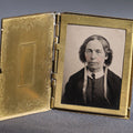 Lot 119 - Antique Tintype Photograph In Brass Book-Form Locket Case, Elderly Woman In Dark Dress, Engraved Floral And Scroll Design