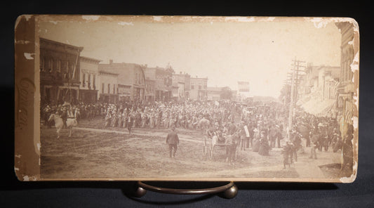 Lot 131 - Antique Board-Mounted Panoramic Photograph Of A Parade On Main Street, Storm Lake, Iowa, Photographed By Coman, Crowds, Horseback Rider, And American Flag