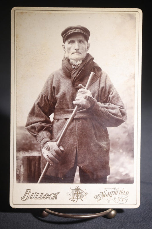 Lot 134 - Antique Cabinet Card Photograph Of A Rugged New England Man In Heavy Coat, Cap, Gloves, And Scarf Holding A Walking Stick, Ink-Inscribed "Joel Simons," Photographed By Bullock, Northfield, Vermont