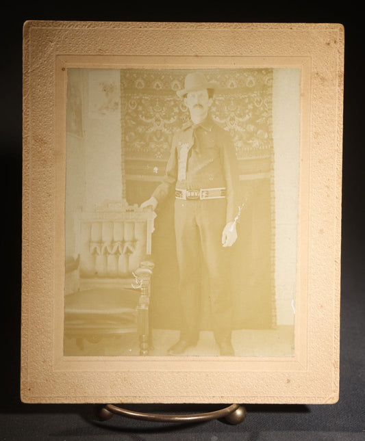 Lot 143 - Antique Board-Mounted Photograph Of A Man In Western Dress With Cowboy Hat, Decorative Shirt, And Fraternal Ribbon Badge With Eagle Device, "Bbv" Belt Buckle