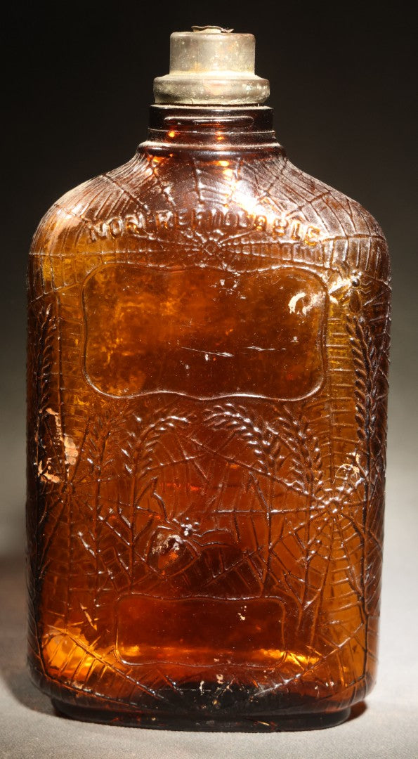 Vintage Embossed Amber Glass Whiskey Bottle with Spider Web, Spider, and Wheat Motifs, Marked "Non Refillable" and "Pat. Pending"