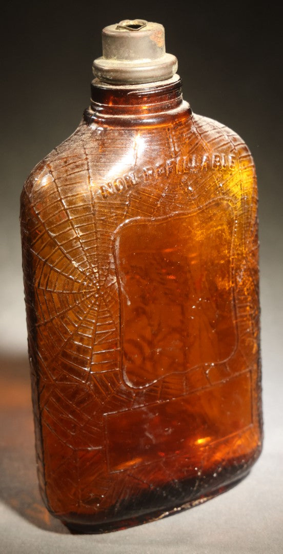 Vintage Embossed Amber Glass Whiskey Bottle with Spider Web, Spider, and Wheat Motifs, Marked "Non Refillable" and "Pat. Pending"