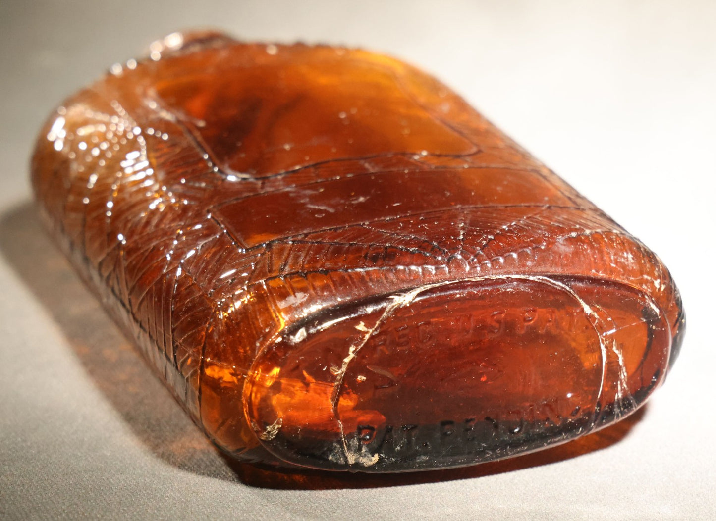 Vintage Embossed Amber Glass Whiskey Bottle with Spider Web, Spider, and Wheat Motifs, Marked "Non Refillable" and "Pat. Pending"