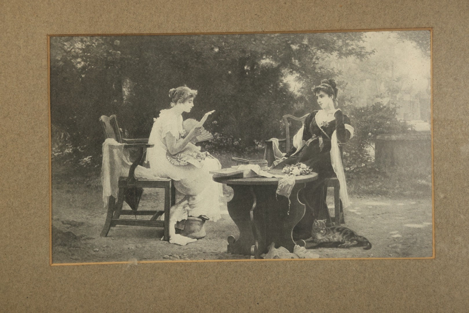Antique Framed Print After "Her First Love Letter" by Marcus Stone (English, 1840-1921), Two Young Women Seated at a Garden Table with a Cat