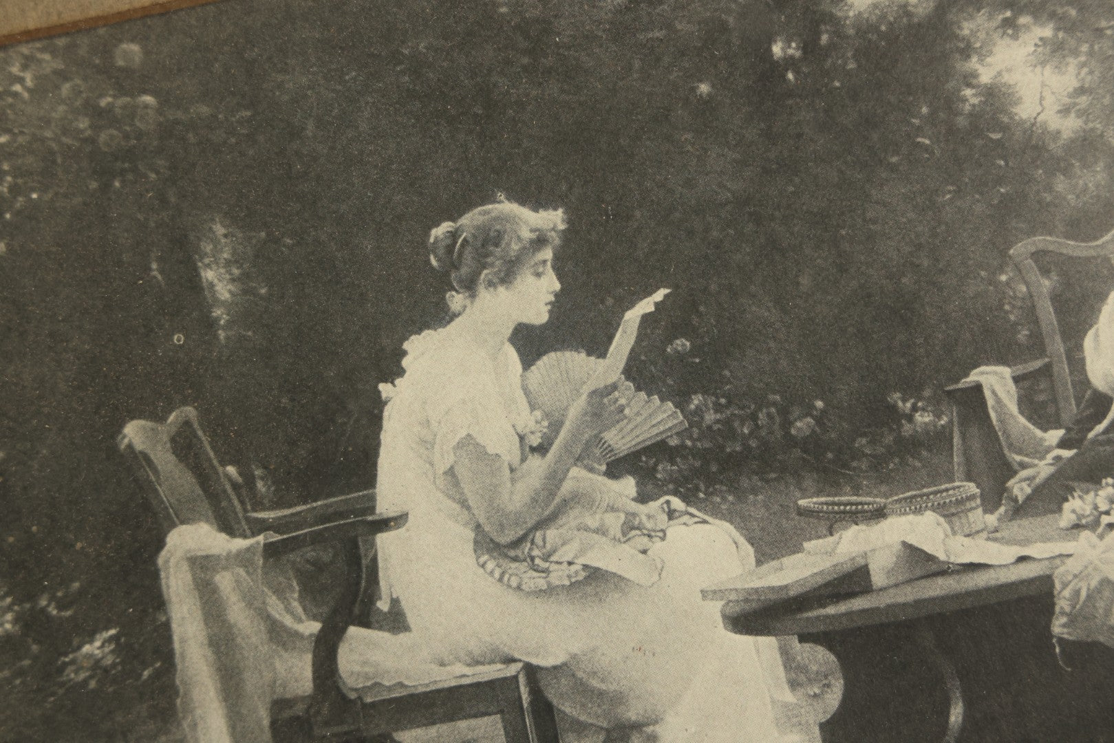Antique Framed Print After "Her First Love Letter" by Marcus Stone (English, 1840-1921), Two Young Women Seated at a Garden Table with a Cat
