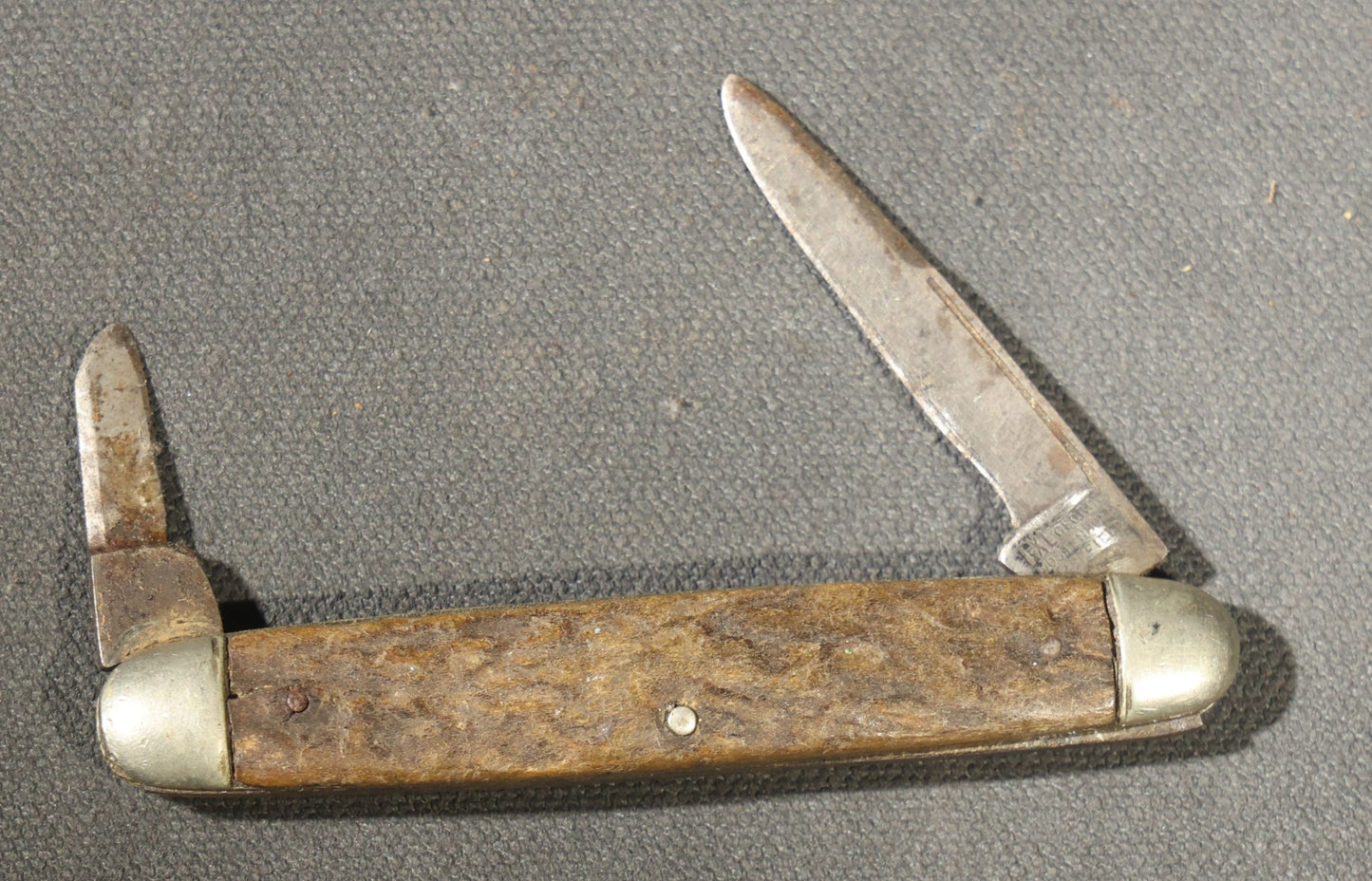 Grouping of Seven Vintage Folding Pocket Knives Including Multi-Tool Camp Knives, Stockman, and Trapper Styles with Bone, Jigged, and Composite Handles