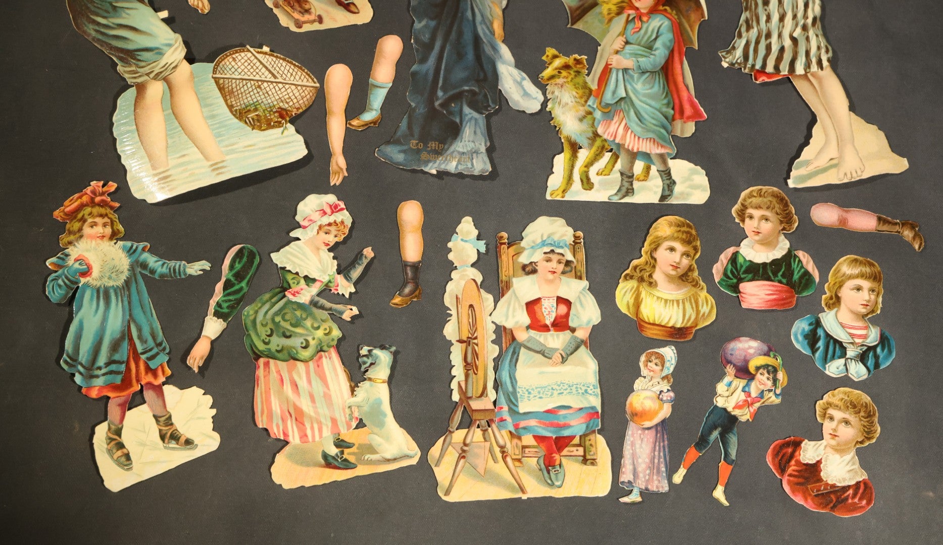 Grouping of 14 Antique Chromolithograph Paper Dolls with Extra Limbs and Accessories Including Raphael Tuck and Sons, Little Red Riding Hood, and Spinning Wheel Figures