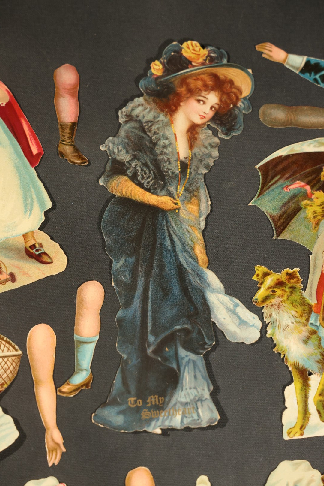 Grouping of 14 Antique Chromolithograph Paper Dolls with Extra Limbs and Accessories Including Raphael Tuck and Sons, Little Red Riding Hood, and Spinning Wheel Figures