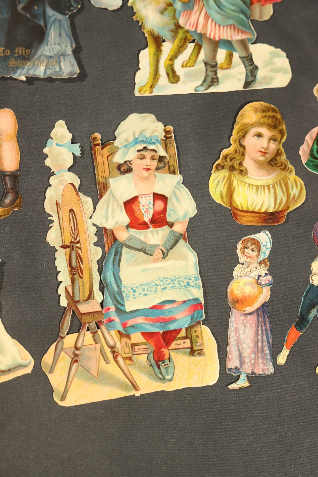 Grouping of 14 Antique Chromolithograph Paper Dolls with Extra Limbs and Accessories Including Raphael Tuck and Sons, Little Red Riding Hood, and Spinning Wheel Figures