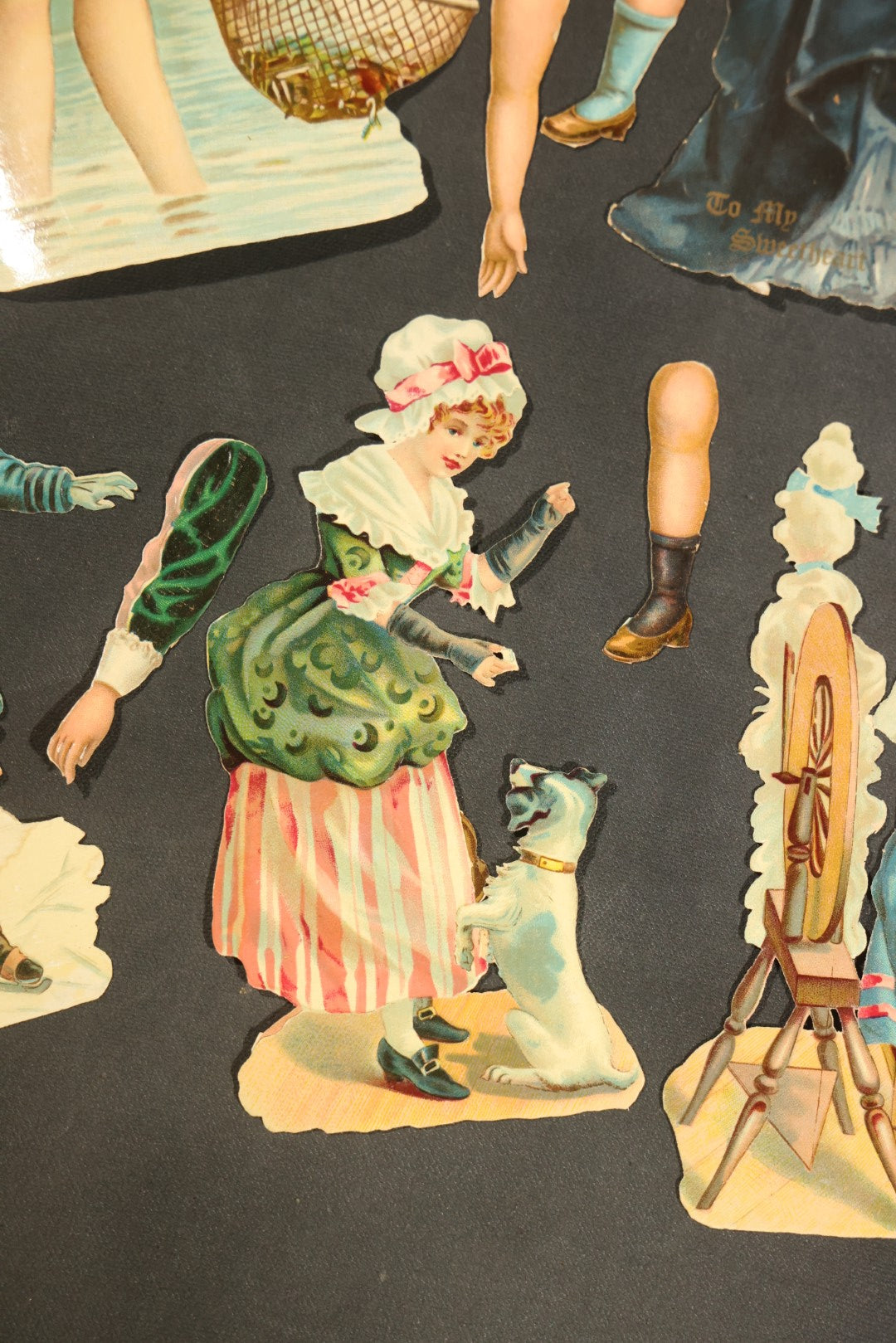 Grouping of 14 Antique Chromolithograph Paper Dolls with Extra Limbs and Accessories Including Raphael Tuck and Sons, Little Red Riding Hood, and Spinning Wheel Figures