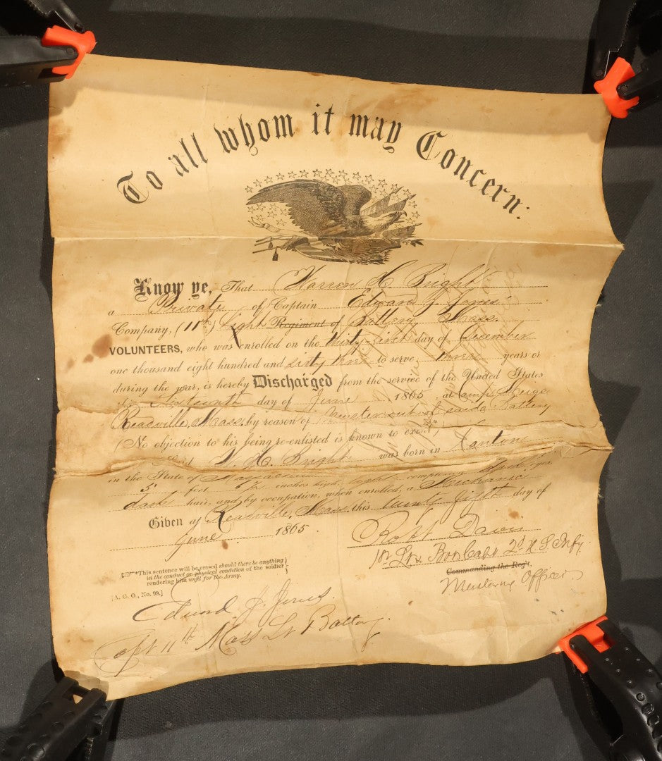 Pair of Antique Civil War Documents, 11th Massachusetts Battery Veteran Volunteers, "Soldiers Memorial" Chromolithograph Roster and Discharge Paper for Warren H. Bright, Captain Edward J. Jones, 1863-1865