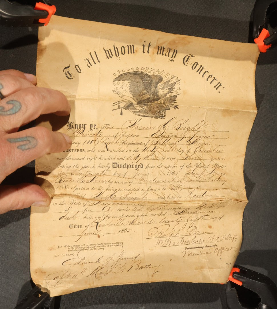 Pair of Antique Civil War Documents, 11th Massachusetts Battery Veteran Volunteers, "Soldiers Memorial" Chromolithograph Roster and Discharge Paper for Warren H. Bright, Captain Edward J. Jones, 1863-1865