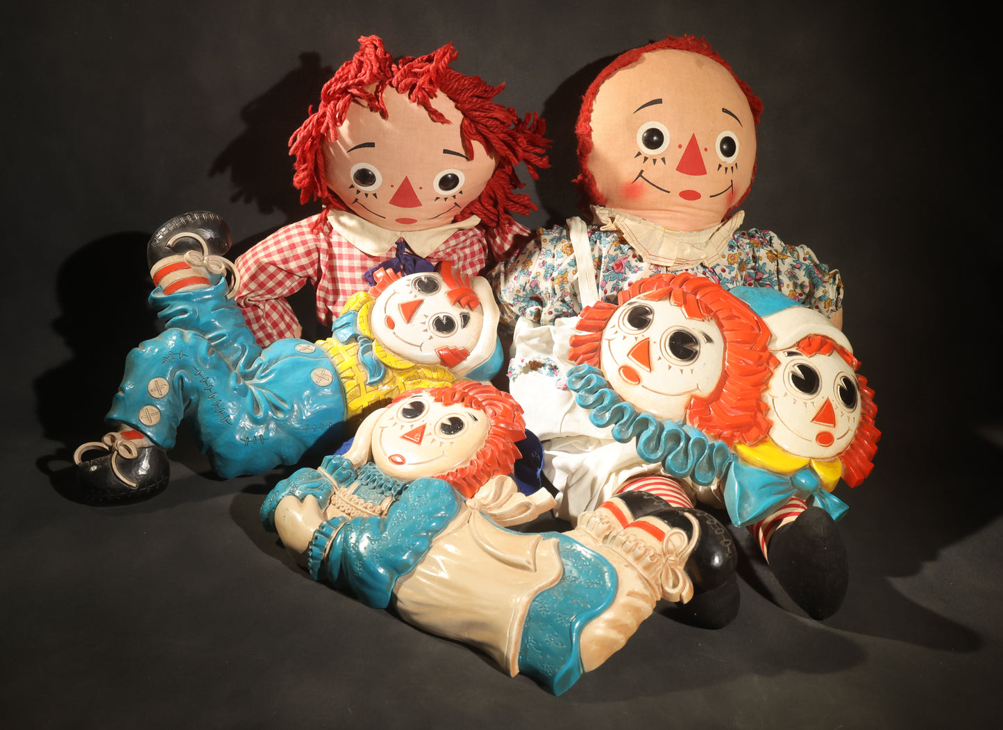 Grouping of Five Vintage Raggedy Ann and Andy Items Including Two Cloth Dolls, 24" L Each, and Three 1970s Plastic Wall Hangings by Dart Industries, Bobbs-Merrill Company Copyright
