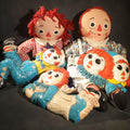 Lot 137 - Grouping of Five Vintage Raggedy Ann and Andy Items Including Two Cloth Dolls, 24" L Each, and Three 1970s Plastic Wall Hangings by Dart Industries, Bobbs-Merrill Company Copyright