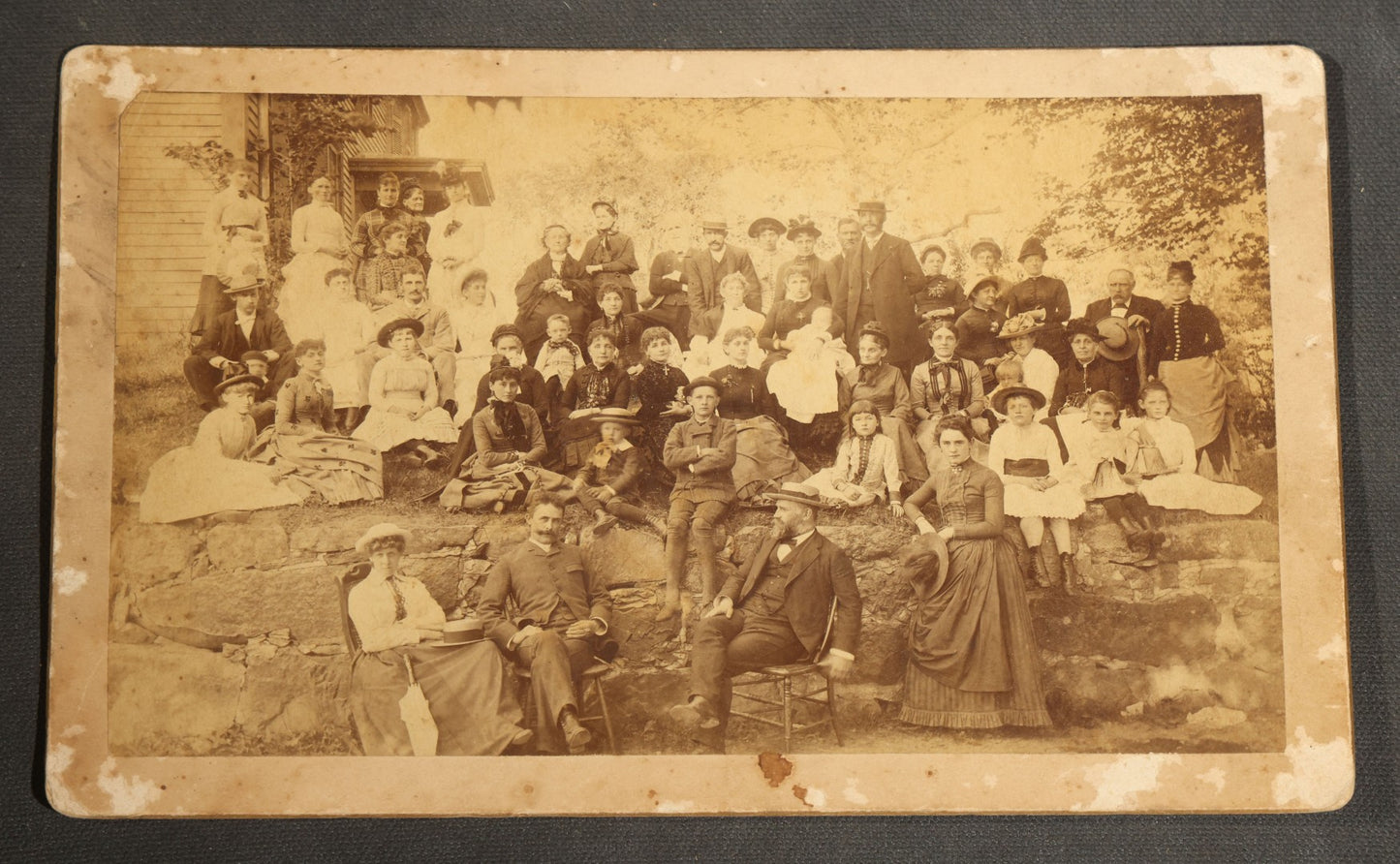 Grouping of Seven Antique Board-Mounted Photographs Including a Church, Street Scene, Couple's Portrait, Family Gathering, School Group, Early Automobile, and Parlor Interior with Telephone