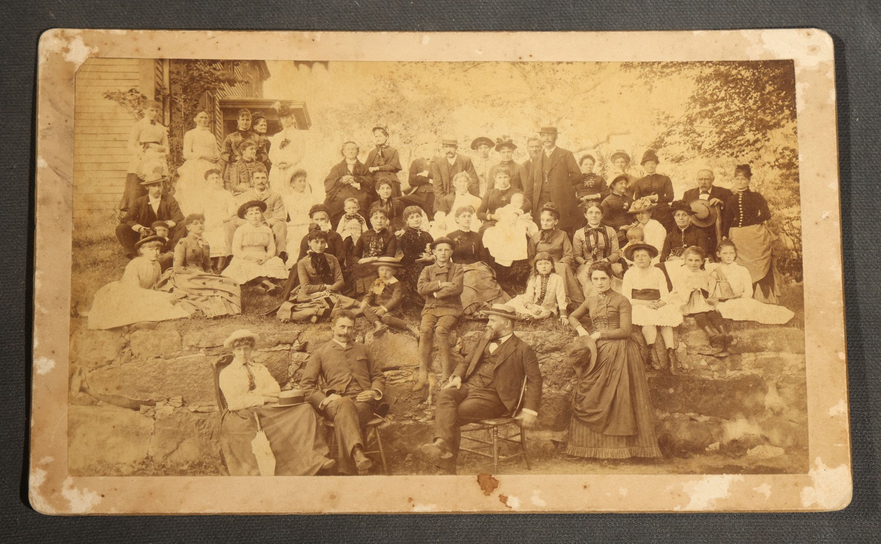 Grouping of Seven Antique Board-Mounted Photographs Including a Church, Street Scene, Couple's Portrait, Family Gathering, School Group, Early Automobile, and Parlor Interior with Telephone