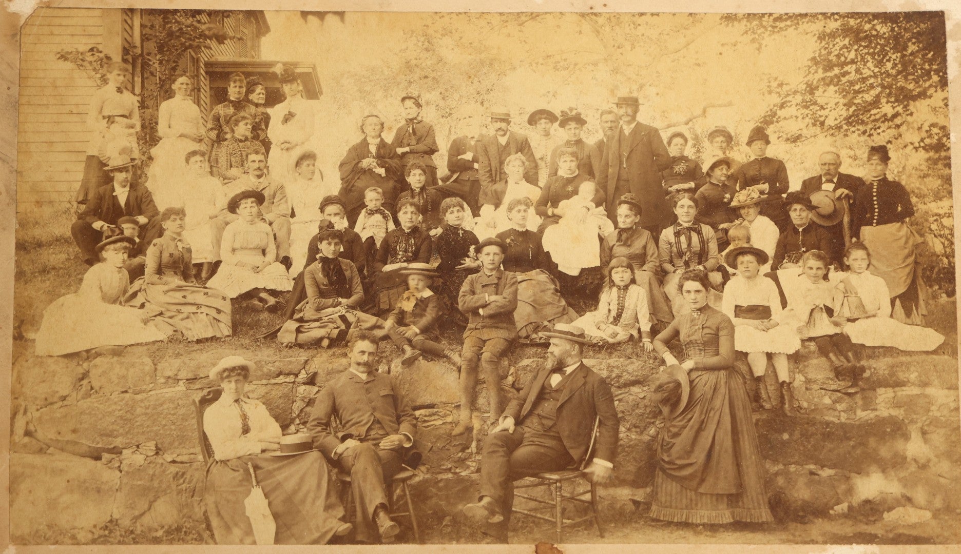 Grouping of Seven Antique Board-Mounted Photographs Including a Church, Street Scene, Couple's Portrait, Family Gathering, School Group, Early Automobile, and Parlor Interior with Telephone