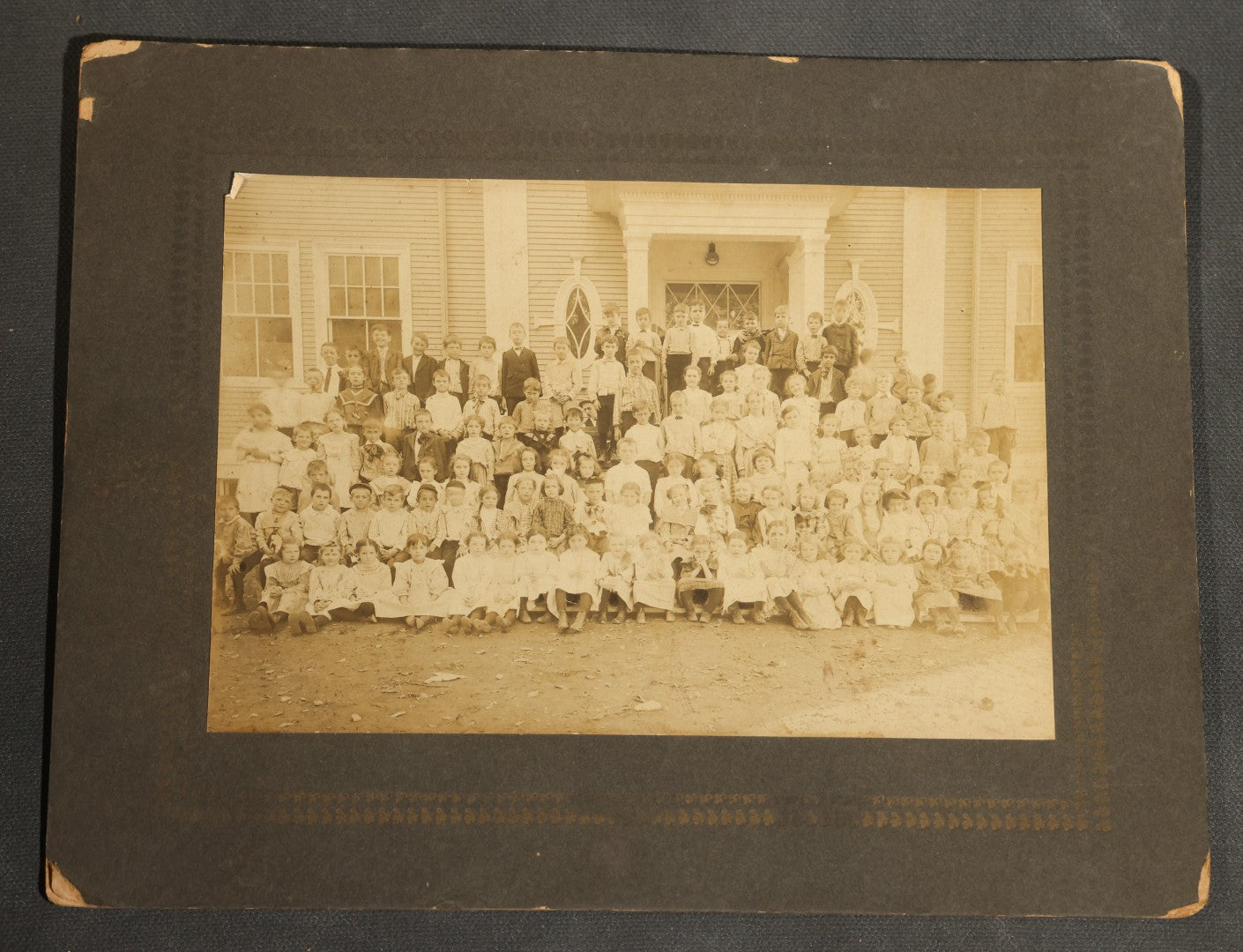Grouping of Seven Antique Board-Mounted Photographs Including a Church, Street Scene, Couple's Portrait, Family Gathering, School Group, Early Automobile, and Parlor Interior with Telephone
