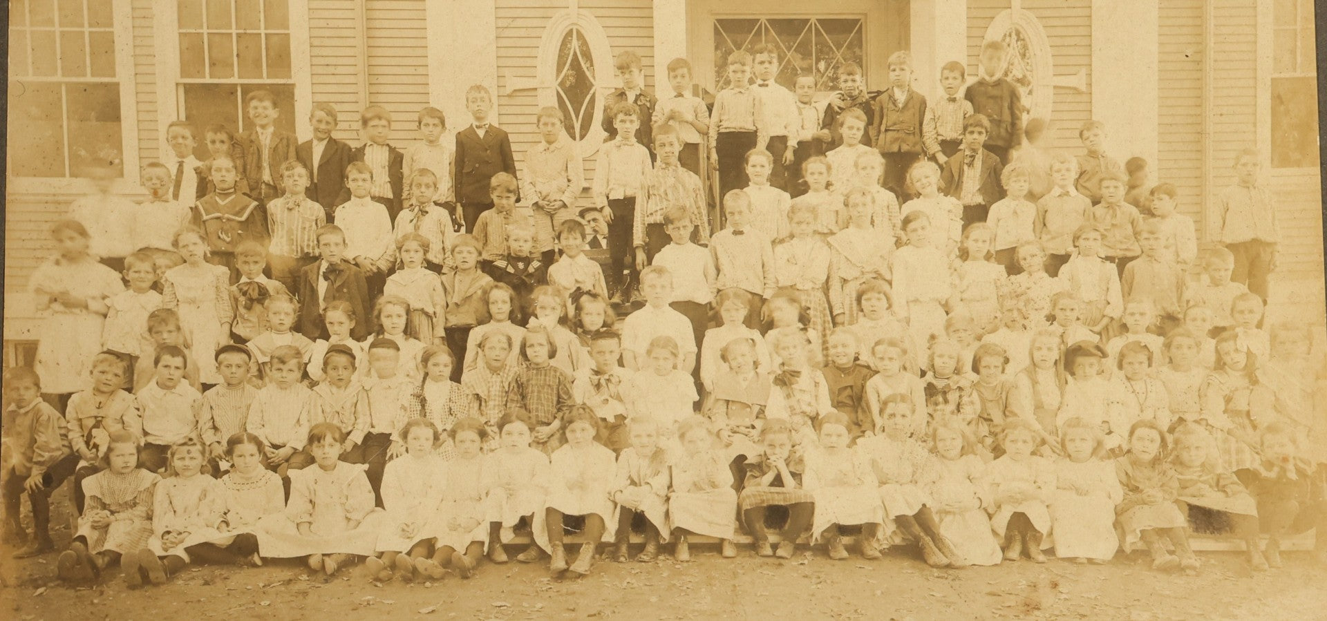 Grouping of Seven Antique Board-Mounted Photographs Including a Church, Street Scene, Couple's Portrait, Family Gathering, School Group, Early Automobile, and Parlor Interior with Telephone