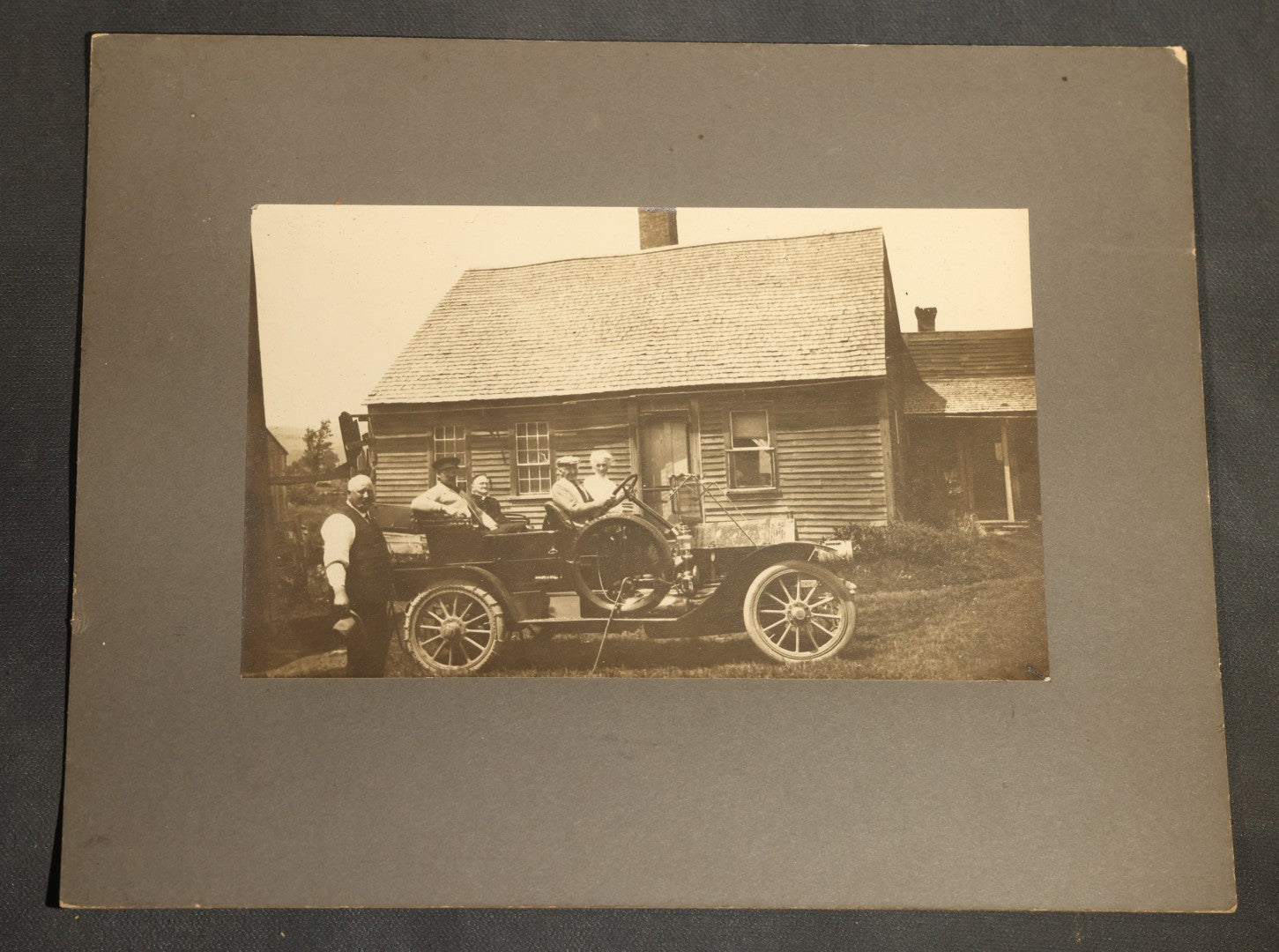 Grouping of Seven Antique Board-Mounted Photographs Including a Church, Street Scene, Couple's Portrait, Family Gathering, School Group, Early Automobile, and Parlor Interior with Telephone