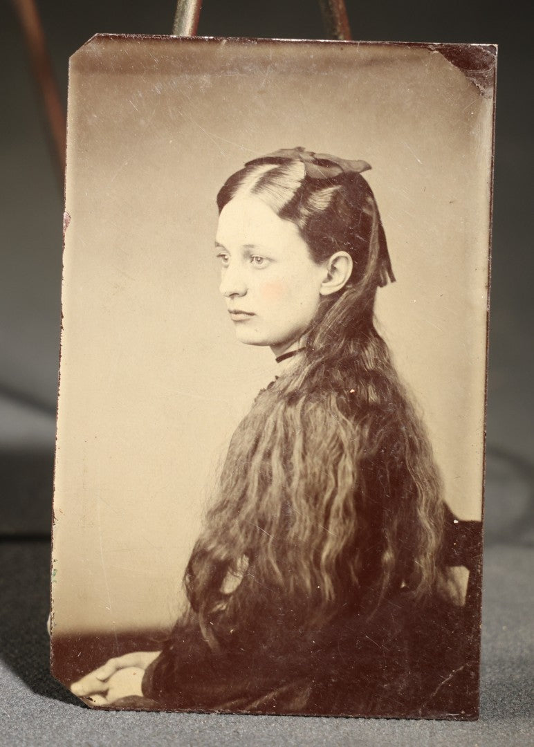 Antique Tintype Photograph of a Young Girl in Profile with Long Wavy Hair and a Dark Hair Bow, Hand-Tinted Cheeks