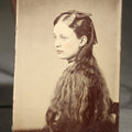 Lot 123 - Antique Tintype Photograph of a Young Girl in Profile with Long Wavy Hair and a Dark Hair Bow, Hand-Tinted Cheeks