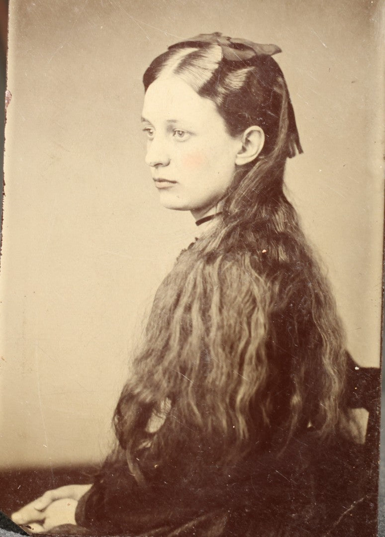 Antique Tintype Photograph of a Young Girl in Profile with Long Wavy Hair and a Dark Hair Bow, Hand-Tinted Cheeks