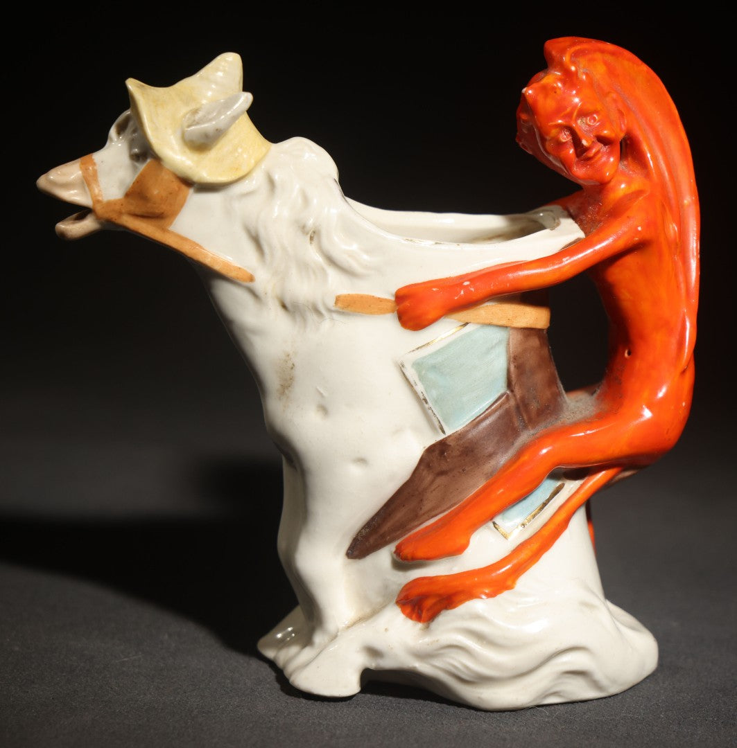 Antique Porcelain Figural Creamer of a Red Devil Riding a White Horse, Likely German, Note Horse Missing Tip of Ear