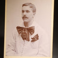 Lot 127 - Antique Cabinet Card Photograph of a Man in a Laced White Shirt with a Large Bow, Possible Performer, Photographed by A.A. Baldwin, Rutland, Vermont