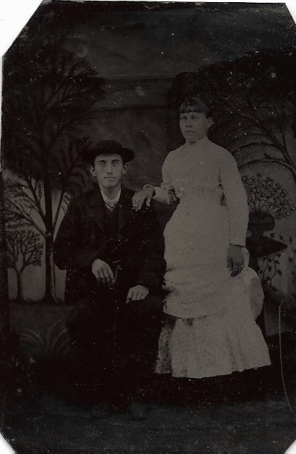 Tintype Photograph of a Man in a Hat Seated Beside a Woman in a White Dress