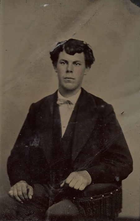 Tintype Photograph of a Seated Young Man with His Arm on an Armrest