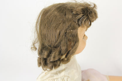 Composition Little Girl Baby Doll with Dress, Moving Blue Eyes, and Curly Brunette Wig, 23"