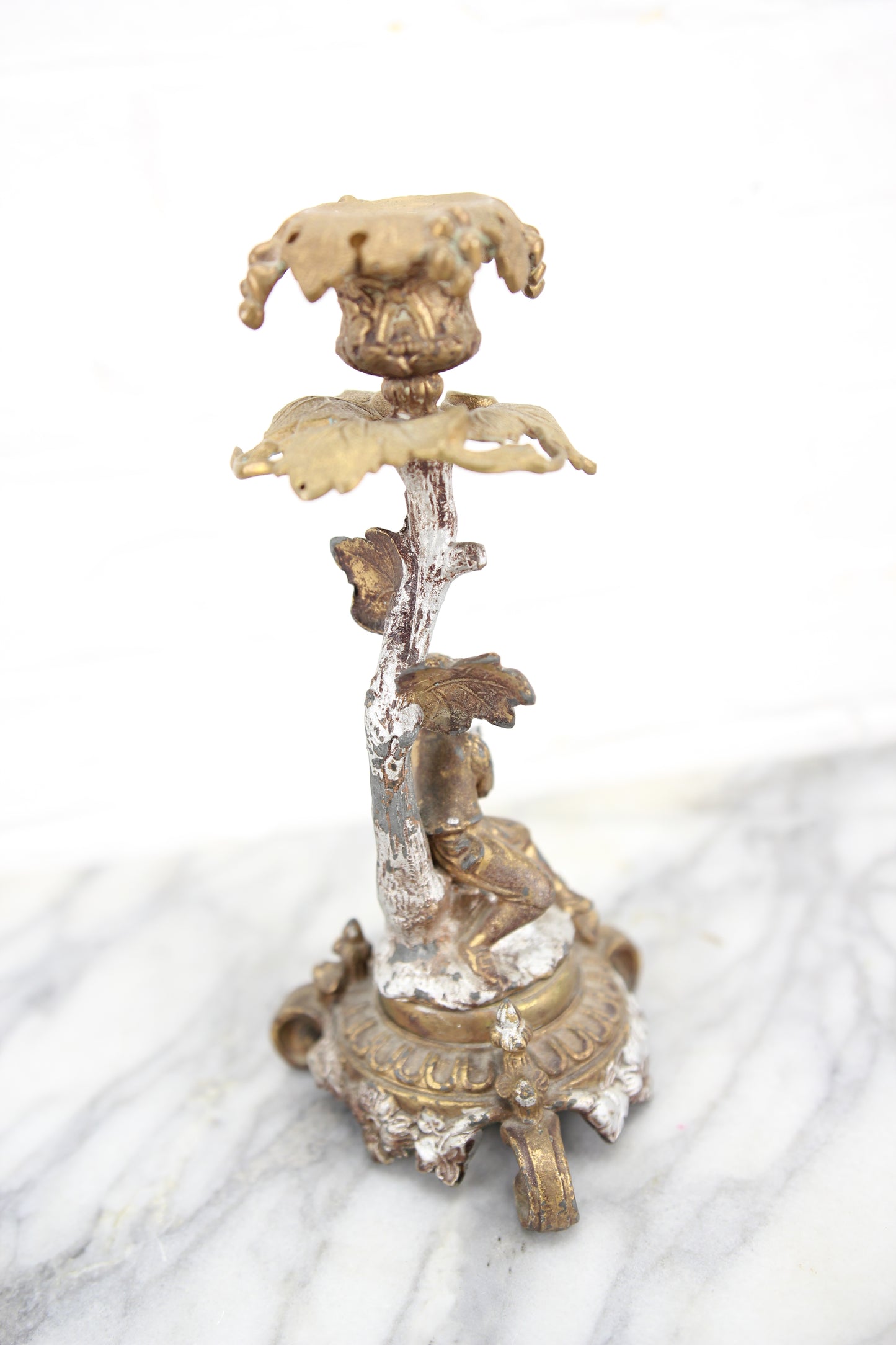 Ornate Brass Candlestick with Figural Man Holding a Bird's Nest