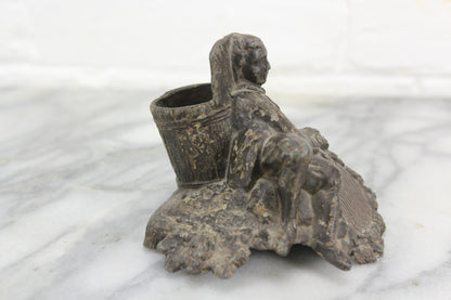 Cast Metal Match Stick Holder with Young Boy Leaning Against a Bucket