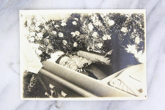 Postmortem Photograph of a Man in His Coffin Surrounded by Flowers