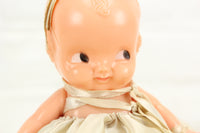 Irwin Kewpie Style Celluloid Baby Doll with Dress and Bow on Base, 6"