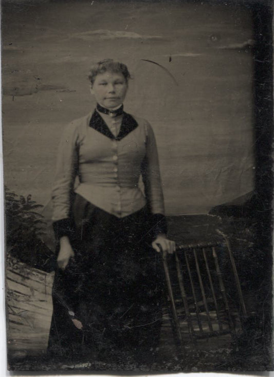 Tintype Photograph of a Standing Woman Next to a Chair