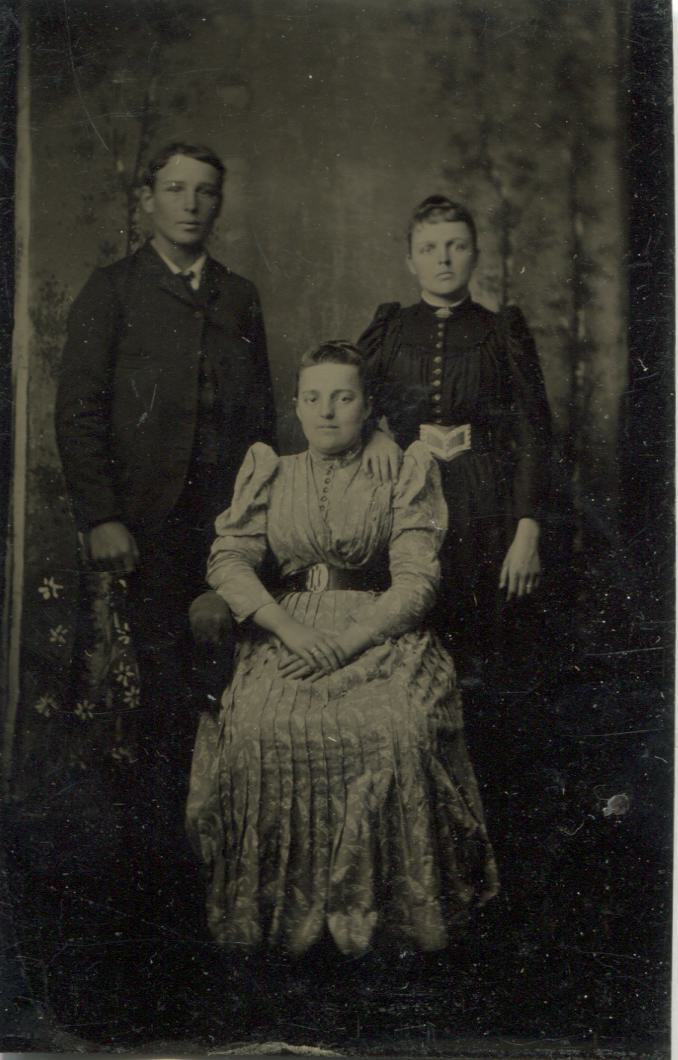 Tintype Photograph of Three Young Adults, Two in Black and One in White